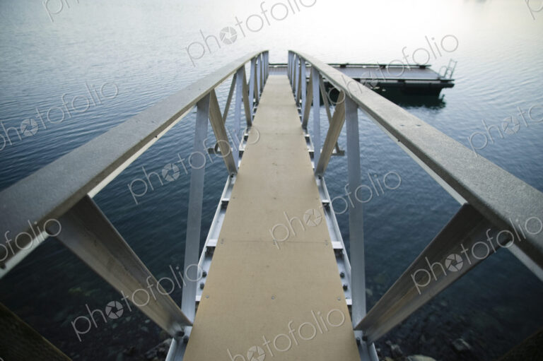 Walkway to jetty in water.