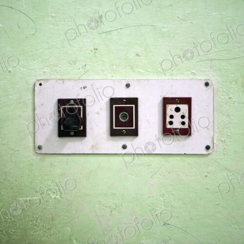 Wall with three electrical sockets in a row on a wall