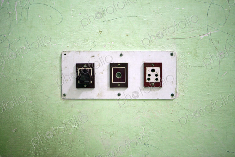 Wall with three electrical sockets in a row on a wall