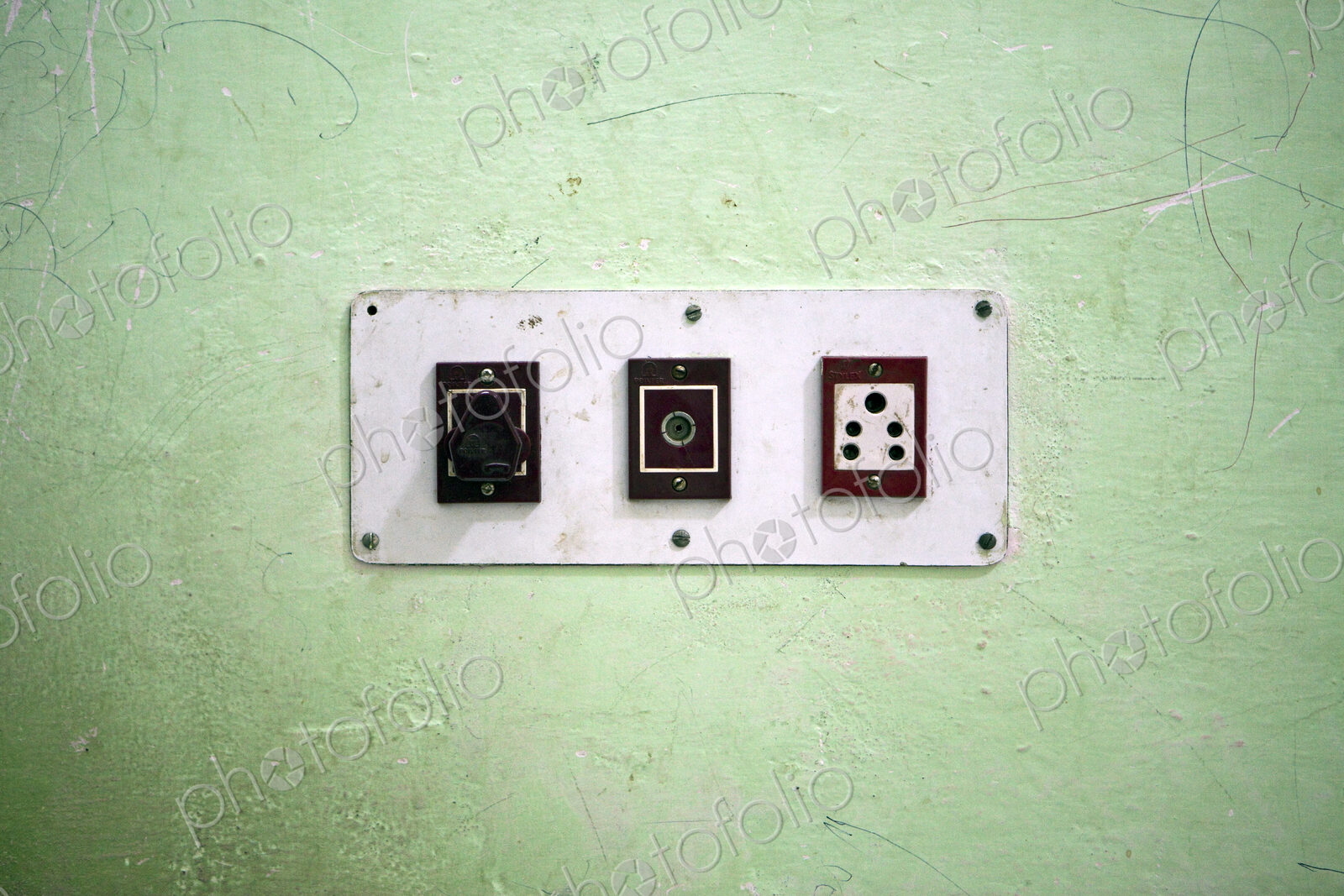 Wall with three electrical sockets in a row on a wall