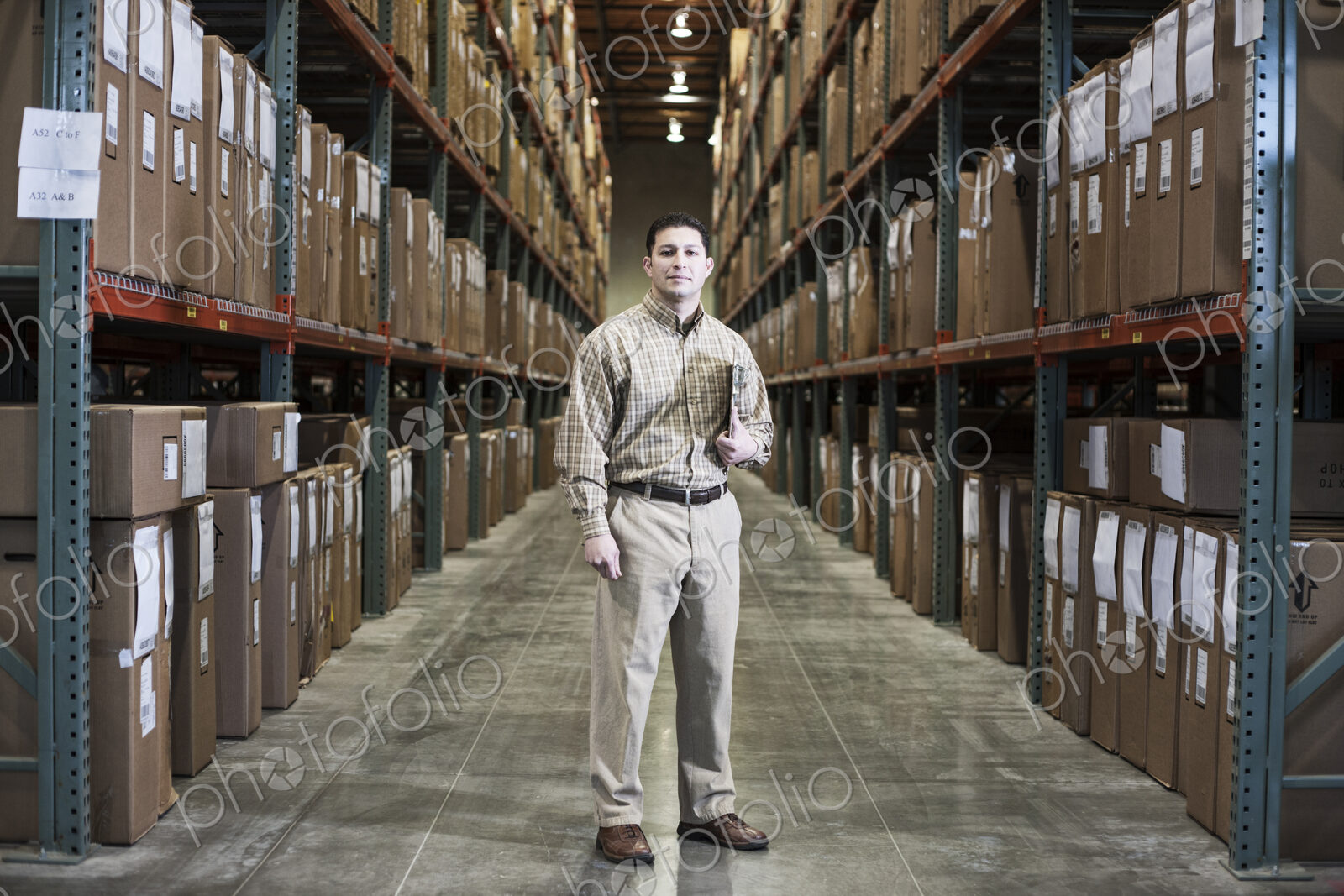 Warehouse worker in an aisle in a distribution warehouse.