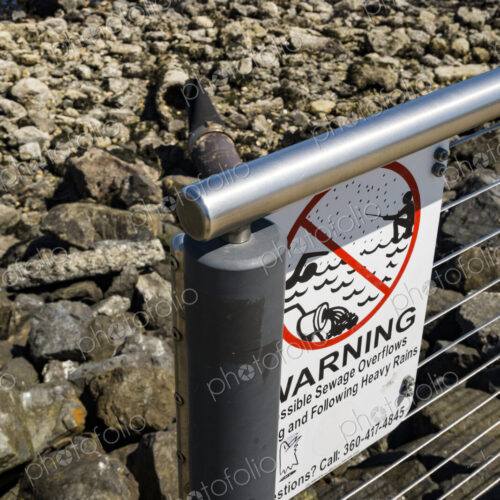 Warning sign for sewage outflow pipe on the Port Angeles waterfront. Warning sign for sewage outflow pipe on the Port Angeles waterfront.