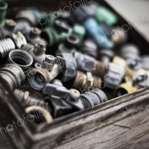 Washers and hose pipe joint fittings in a wooden box in the greenhouse. Washers and hose pipe joint fittings in a wooden box in the greenhouse.