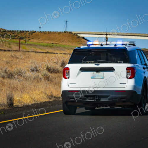 Washington State Trooper vehicle with lights on pulling over a vehicle. Washington State Trooper vehicle with lights on pulling over a vehicle.