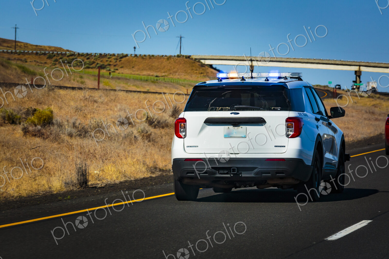 Washington State Trooper vehicle with lights on pulling over a vehicle.