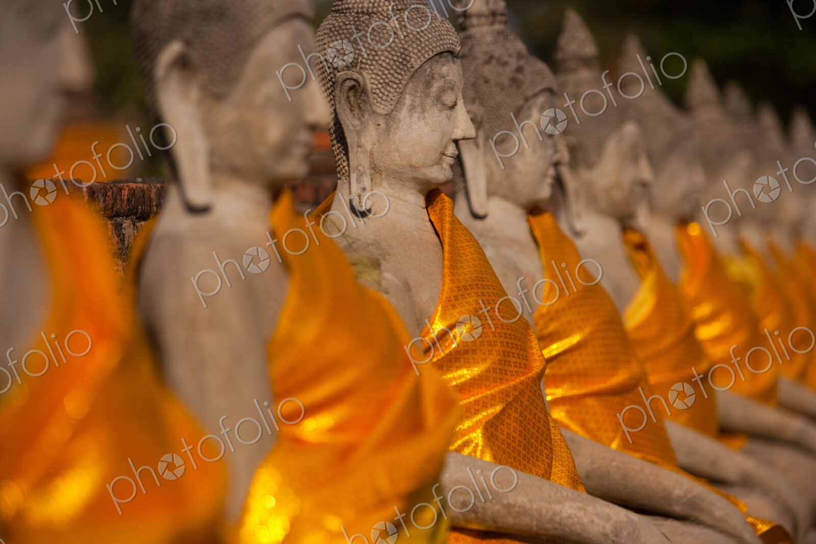 Wat Yai Chai Mongkon, a historic Buddhist temple. Rows of seated Buddha statues,…