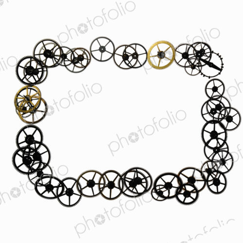 Watch gears, small precision made cog wheels arranged in a rectangular frame shape.…