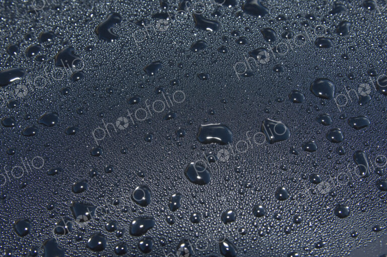 Water droplets on a car windscreen.