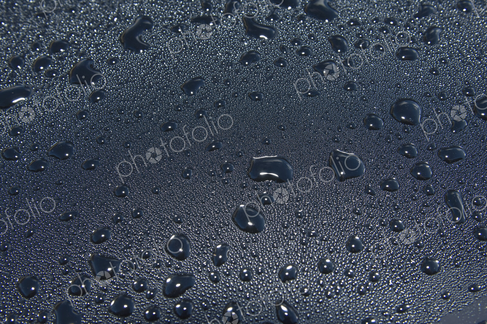 Water droplets on a car windscreen.