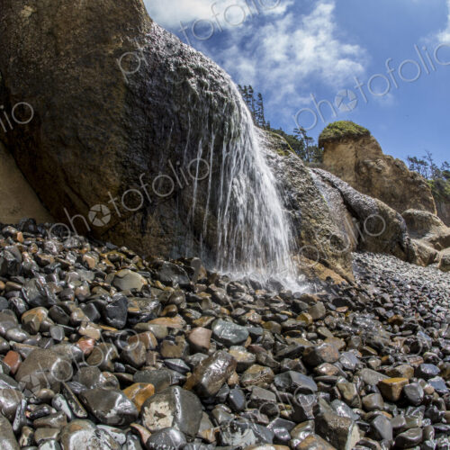 Water falling on rocky beach at Hug Point state park.