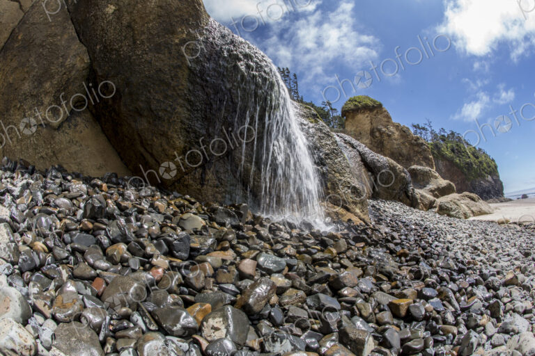 Water falling on rocky beach at Hug Point state park.