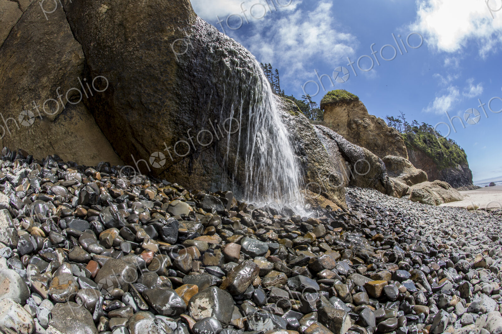 Water falling on rocky beach at Hug Point state park.