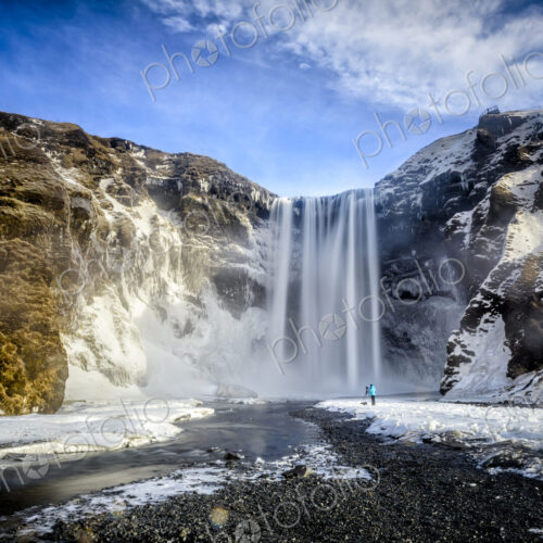 Waterfall pouring over icy cliffs in remote landscape Waterfall pouring over icy cliffs in remote landscape