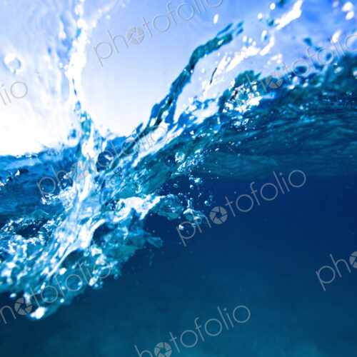 Wave splashing on the camera lens, an over under view. Wave splashing on the camera lens, an over under view.