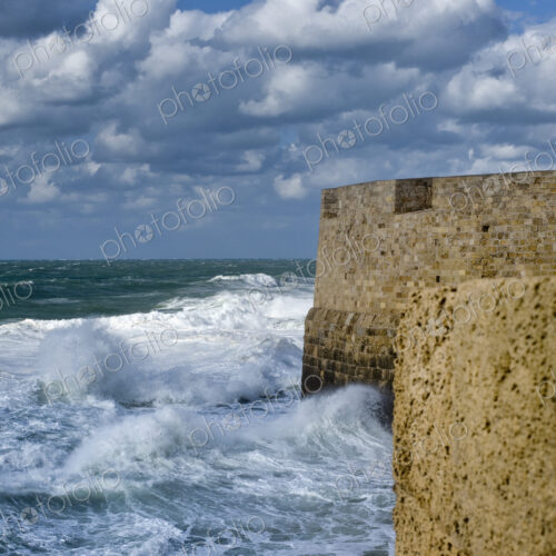 Waves Breaking Against Ancient Walls