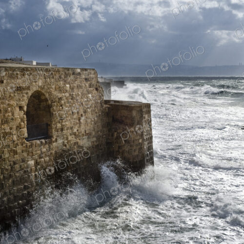 Waves Breaking Against Ancient Walls During A Storm Waves Breaking Against Ancient Walls During A Storm