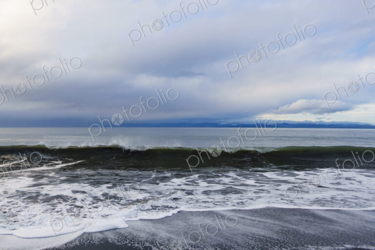 Waves breaking on beach along the Strait of Juan de Fuca, Port Angeles, WA USA