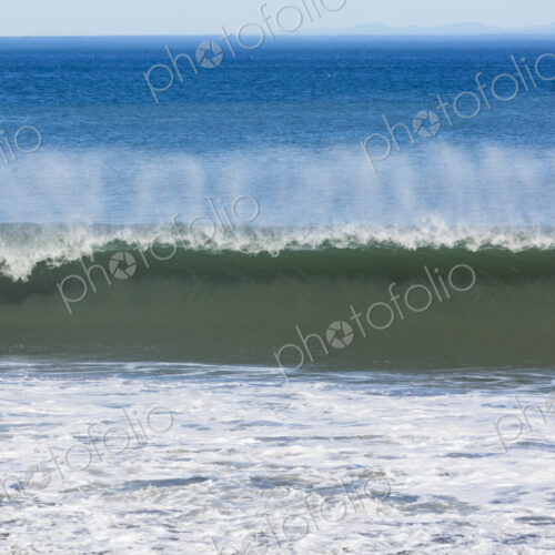 Waves reaching the shore and breaking on the sand. Waves reaching the shore and breaking on the sand.