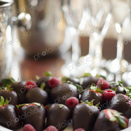 Wedding dessert. Plate of hand-dipped organic strawberries, fruit in artisinal…