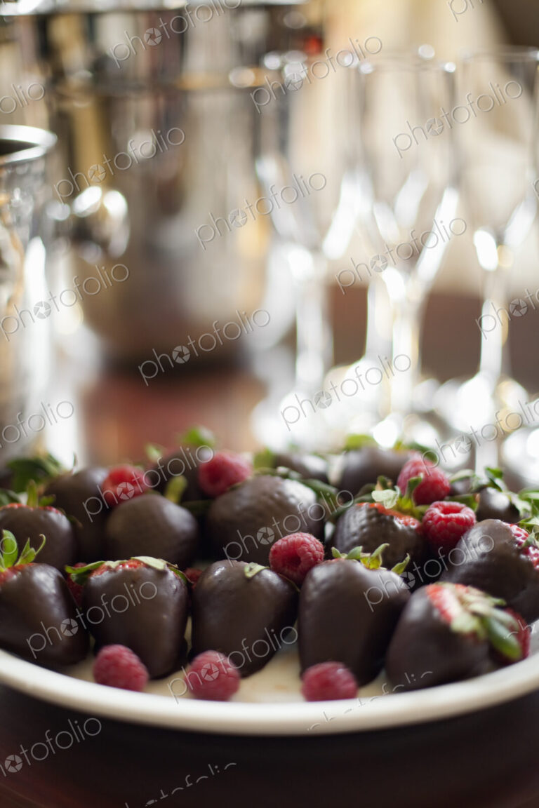 Wedding dessert. Plate of hand-dipped organic strawberries, fruit in artisinal…