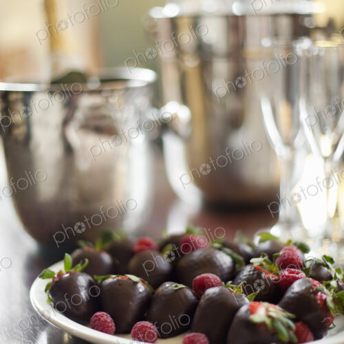 Wedding dessert. Plate of hand-dipped organic strawberries, fruit in artisinal…