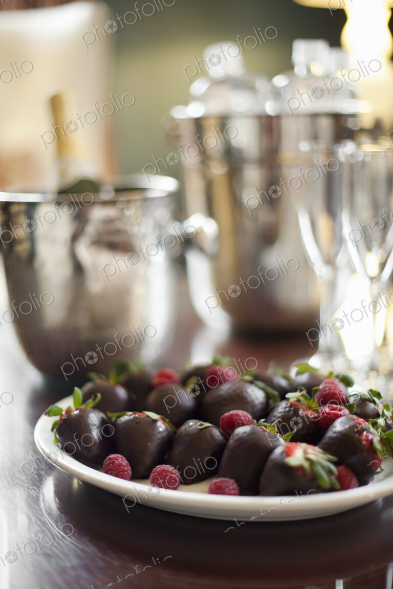 Wedding dessert. Plate of hand-dipped organic strawberries, fruit in artisinal…