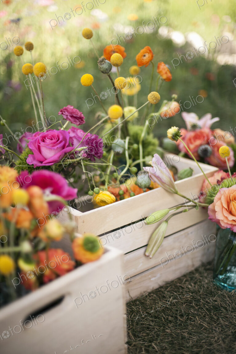 Wedding table decorations. A wooden box of fresh flowers, delicate and brightly…