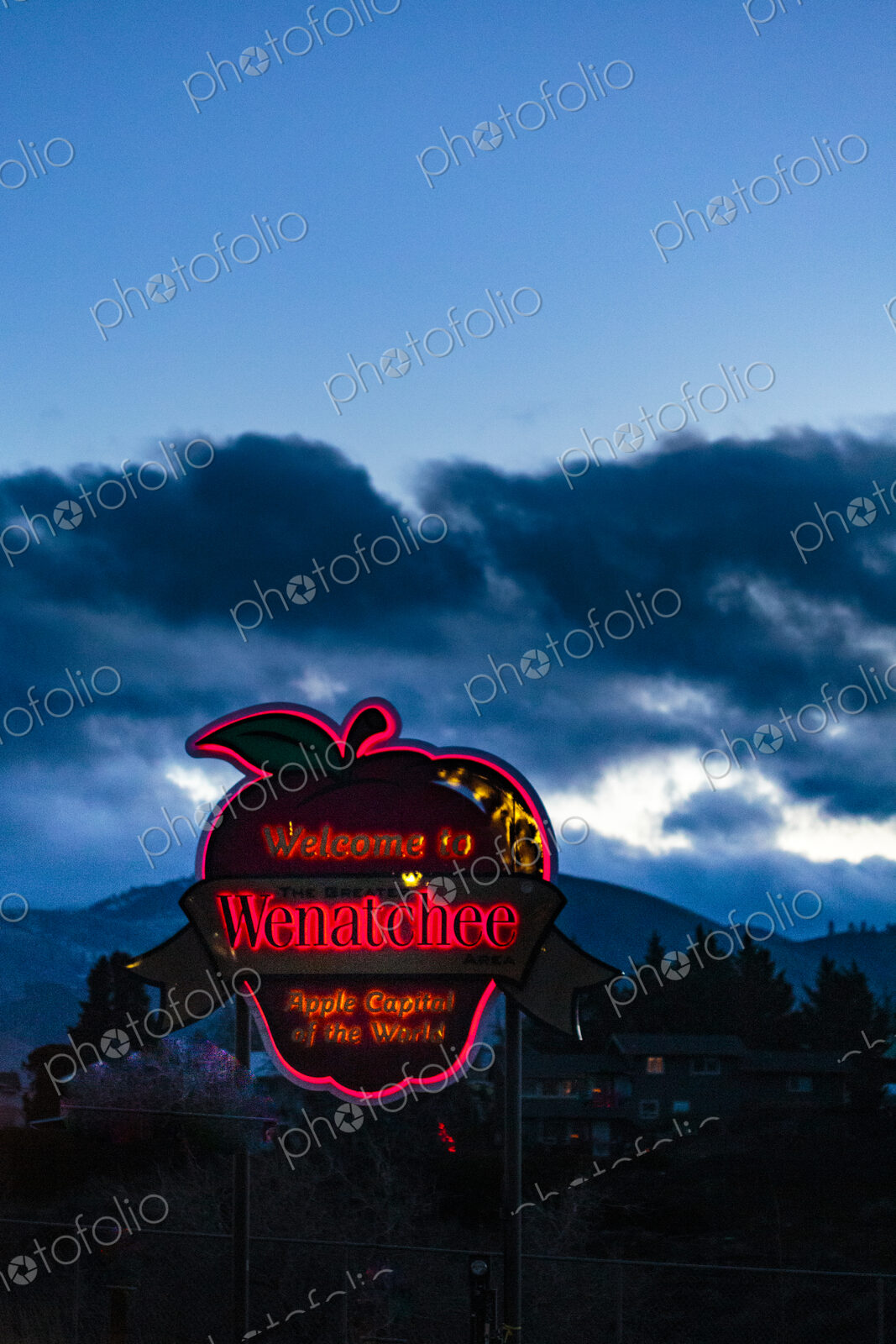 Welcome to Wenatchee town sign, Chelan County, an apple shape neon sign, under dark…