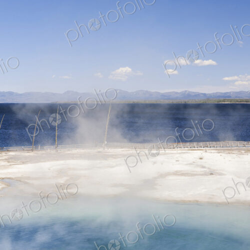 West Thumb geyser basin, a volcanic spring, steam rising from the water. West Thumb geyser basin, a volcanic spring, steam rising from the water.