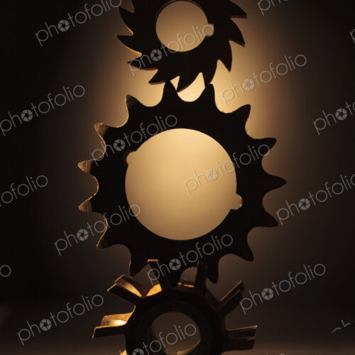 Wheels as gears, a balanced stack of three different metal cog wheels with different… Wheels as gears, a balanced stack of three different metal cog wheels with different…