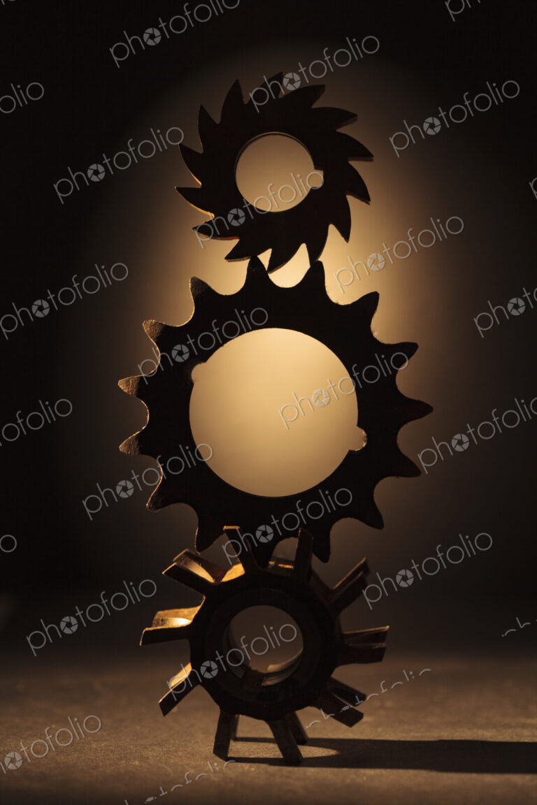 Wheels as gears, a balanced stack of three different metal cog wheels with different…