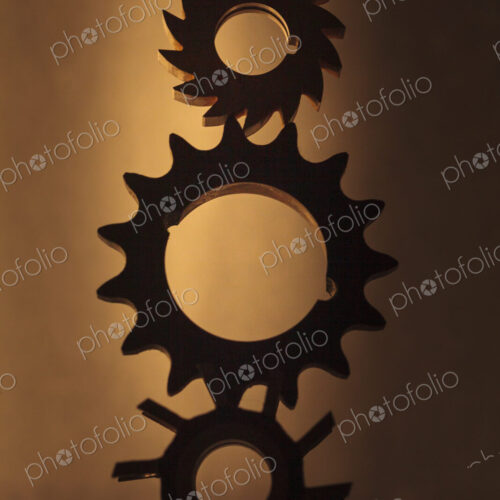 Wheels as gears, a balanced stack of three different metal cog wheels with different… Wheels as gears, a balanced stack of three different metal cog wheels with different…
