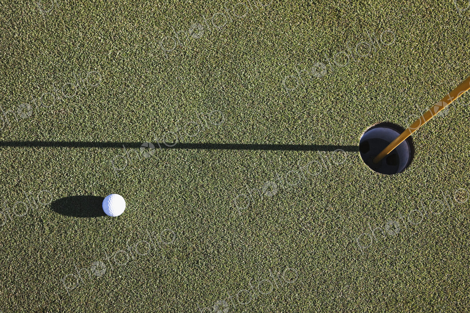 White Golf Ball Near the Cup