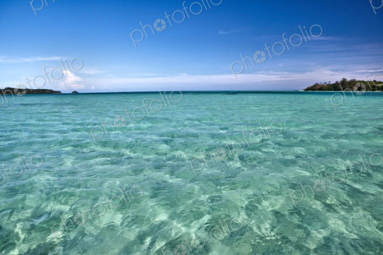 White Sand Seen Under Light Green Shallow Water