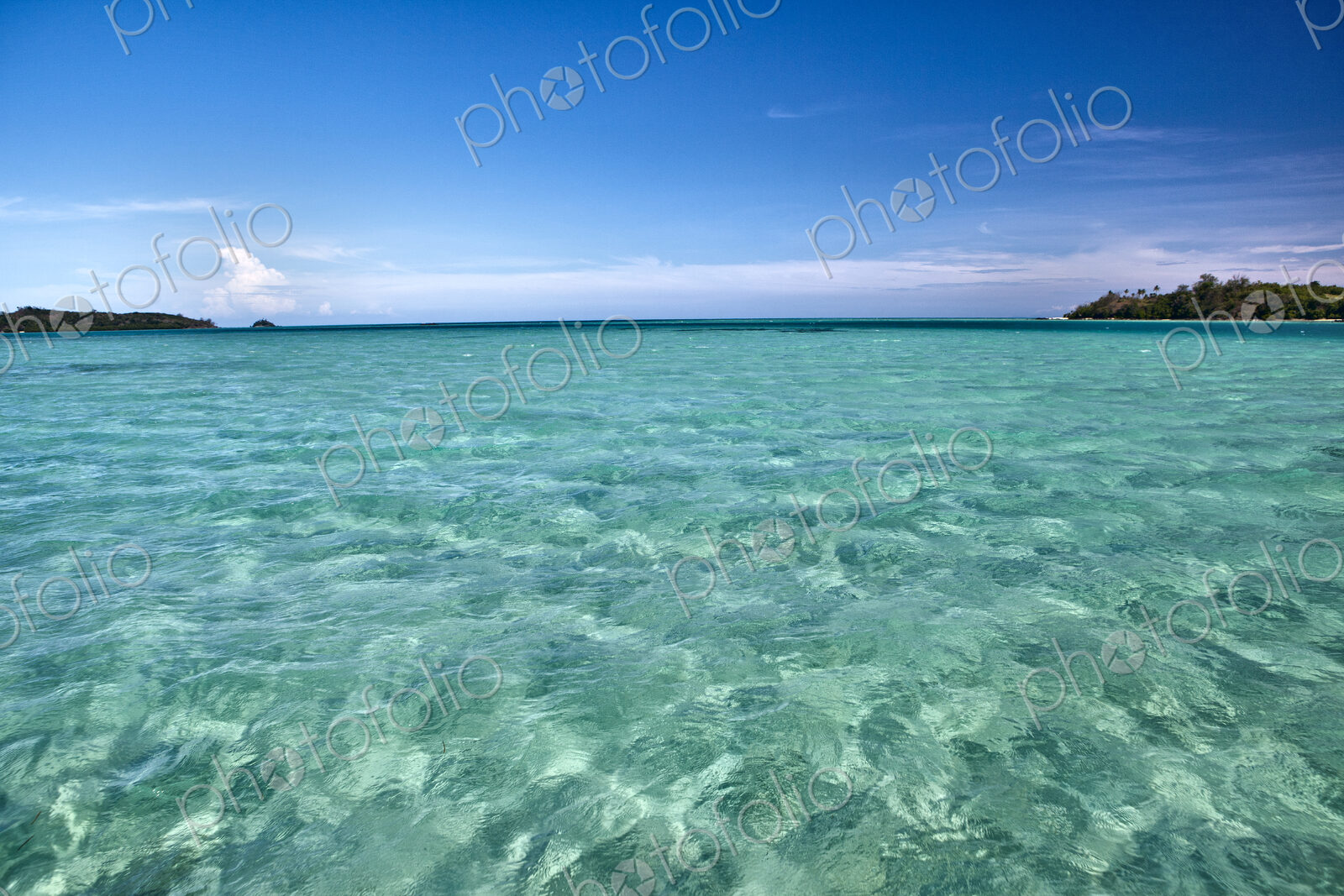 White Sand Seen Under Light Green Shallow Water