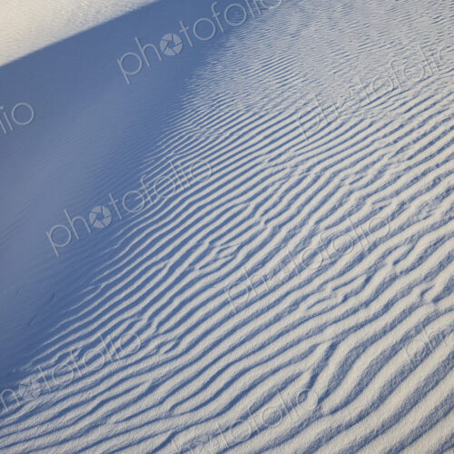 White Sands National Park, Alamogordo, view of a white sand slope with ridges and shadows. White Sands National Park, Alamogordo, view of a white sand slope with ridges and shadows.