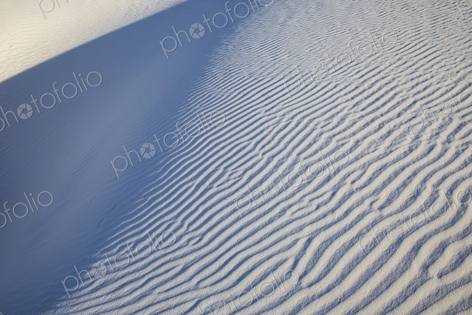 White Sands National Park, Alamogordo, view of a white sand slope with ridges and shadows.