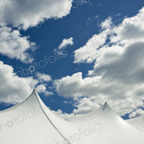 White Tent Top Against a Cloudy Sky White Tent Top Against a Cloudy Sky