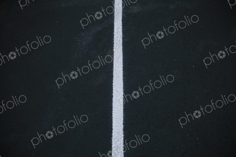 White center line on a black asphalt surface.