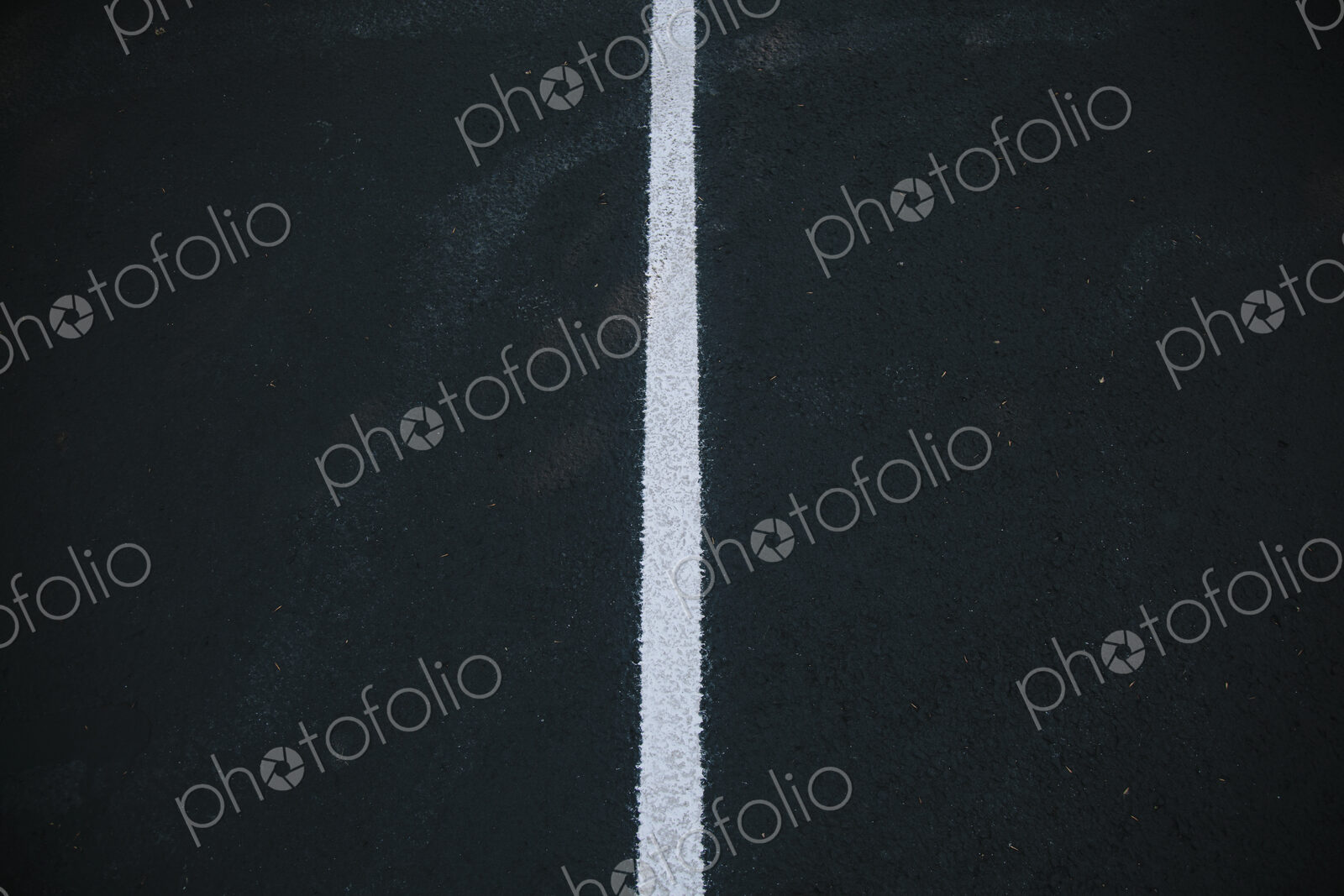 White center line on a black asphalt surface.