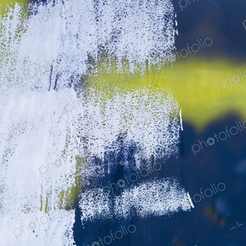White, yellow and black paint covering graffiti tags on building wall White, yellow and black paint covering graffiti tags on building wall