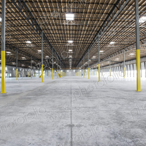 Wide angle interior view of largeempty warehouse and loading dock doors Wide angle interior view of largeempty warehouse and loading dock doors