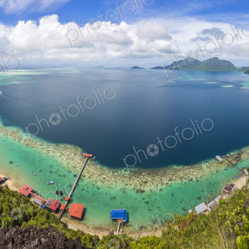 Wide angle view along coastline of tropical island, mountains in the distance. Wide angle view along coastline of tropical island, mountains in the distance.