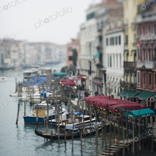 Wide canal in Venice, with boats and traditional gondolas moored Wide canal in Venice, with boats and traditional gondolas moored