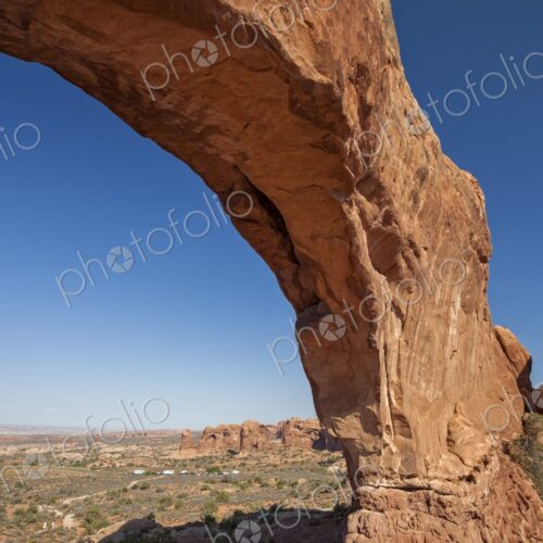 Wide view of North Window Arch in Arches National Park, Utah, framing the vast desert…