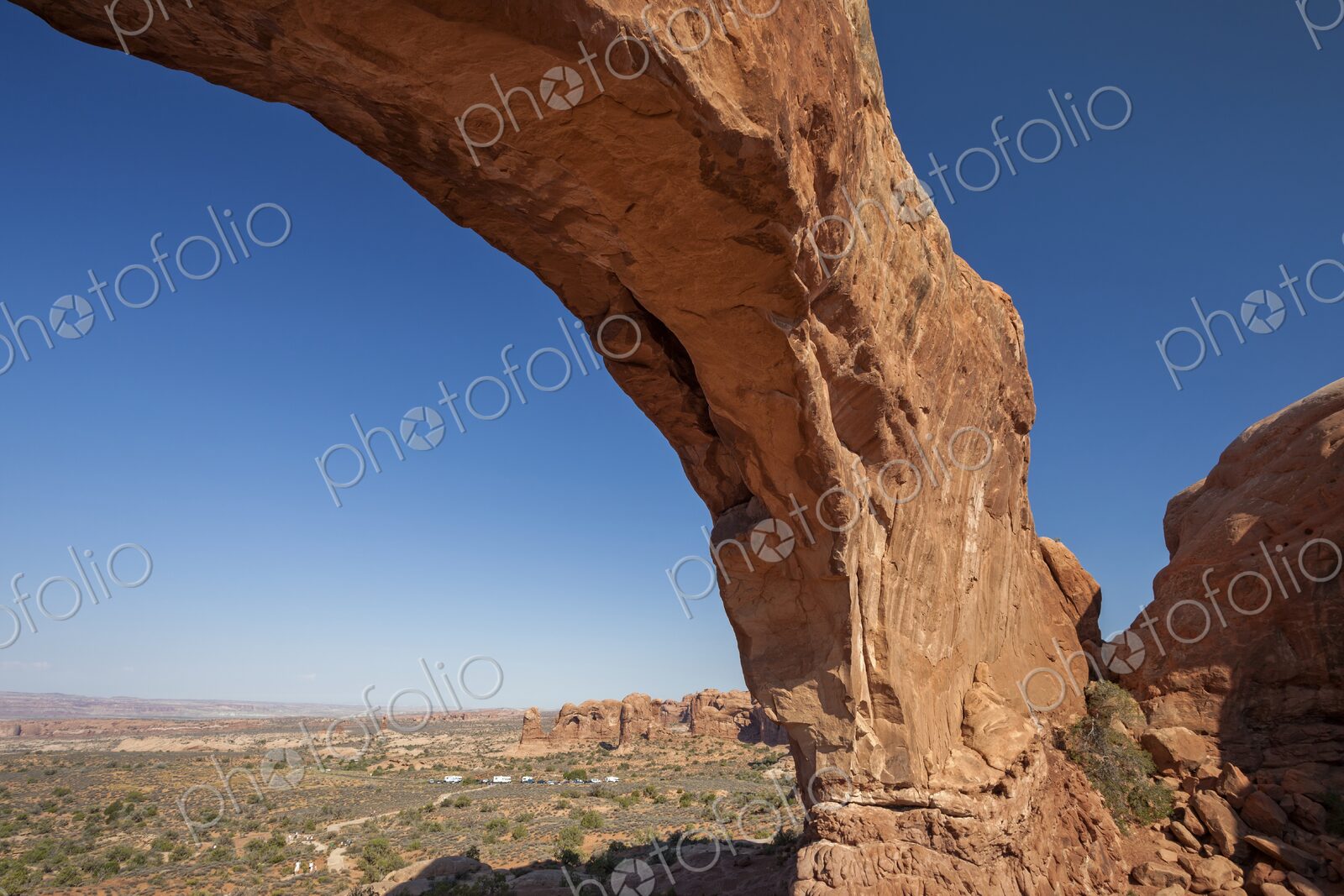 Wide view of North Window Arch in Arches National Park, Utah, framing the vast desert…