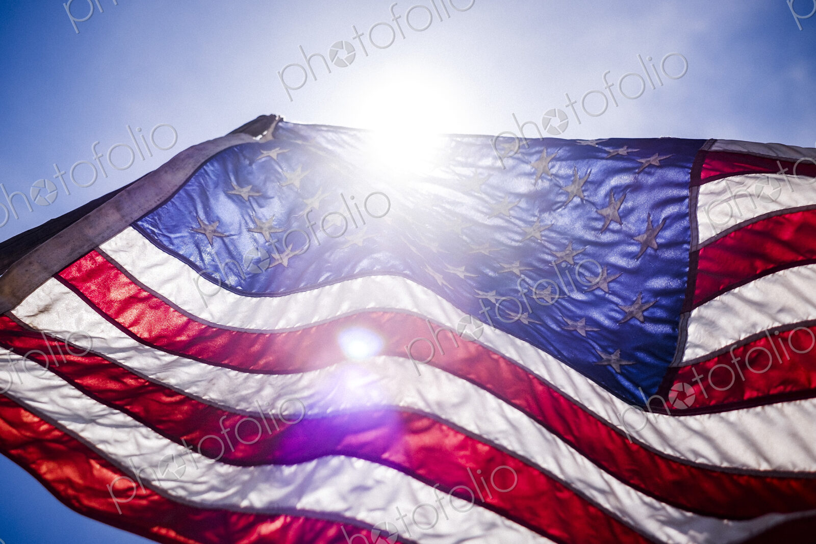 Wind blowing American flag on sunny day