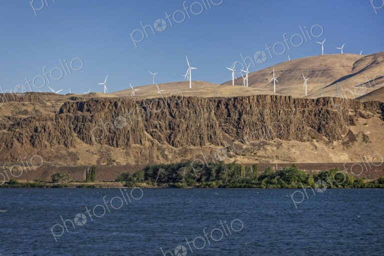 Wind turbines line the hills above the Columbia River Gorge, seen from the Oregon side…