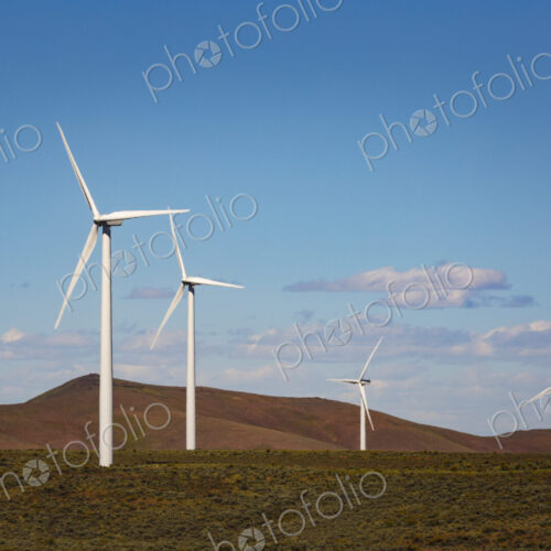 Wind turbines on the rolling hills of Kittikas county in Washington state, tall white… Wind turbines on the rolling hills of Kittikas county in Washington state, tall white…