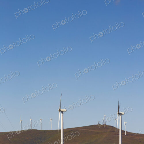 Wind turbines on the rolling hills of Kittikas county in Washington state, tall white… Wind turbines on the rolling hills of Kittikas county in Washington state, tall white…